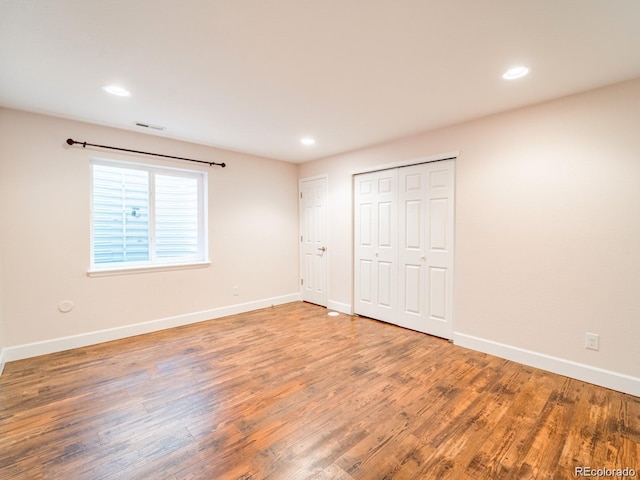 3472 Harvard Pl, Broomfield, CO 80023 - unfurnished bedroom with wood finished floors, baseboards, recessed lighting, and a closet