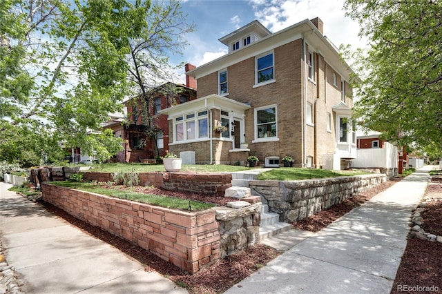 american foursquare style home with a chimney