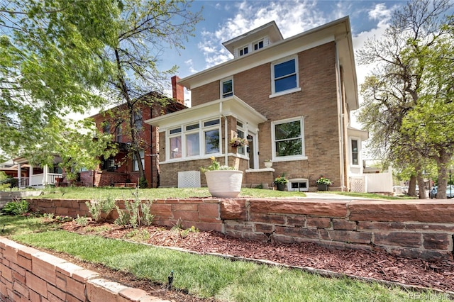 rear view of house featuring brick siding