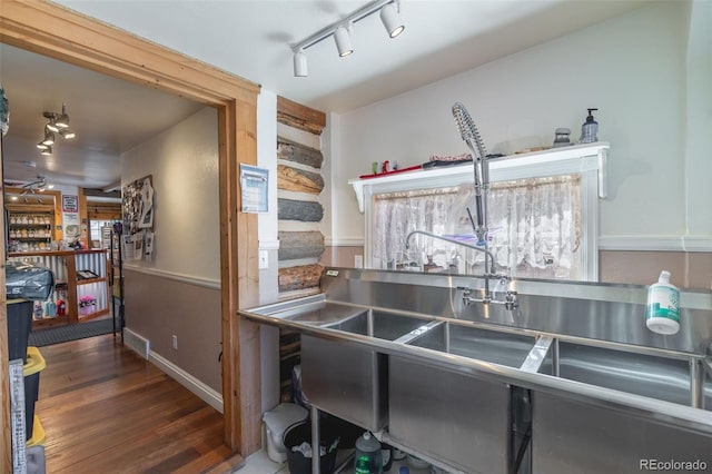 kitchen featuring dark hardwood / wood-style flooring and track lighting