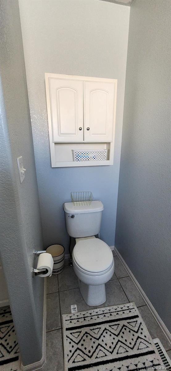 bathroom featuring tile patterned floors and toilet