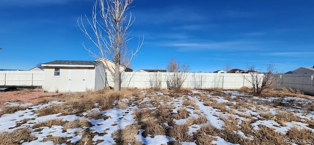 yard layered in snow with a storage unit