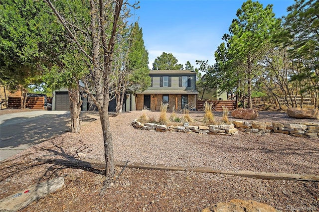 2020 Forest Ridge Dr, Colorado Springs, CO 80918 - view of front of home featuring brick siding, driveway, and an attached garage