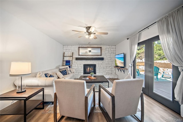 2020 Forest Ridge Dr, Colorado Springs, CO 80918 - living room with light wood-style floors, a stone fireplace, french doors, and ceiling fan