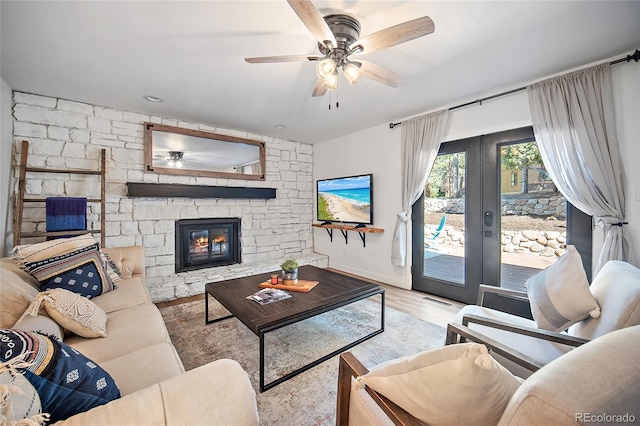 2020 Forest Ridge Dr, Colorado Springs, CO 80918 - living area with a fireplace, baseboards, a ceiling fan, and wood finished floors