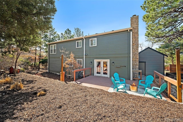 2020 Forest Ridge Dr, Colorado Springs, CO 80918 - rear view of house featuring an outdoor fire pit, french doors, and a chimney