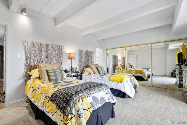 bedroom with beam ceiling, light carpet, a textured ceiling, and a closet