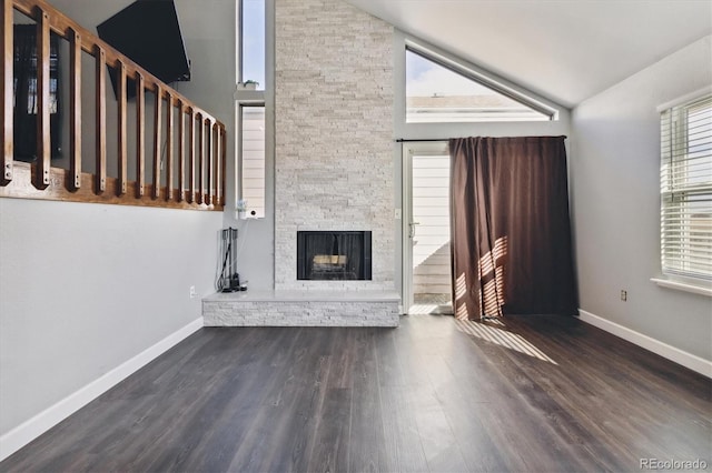 unfurnished living room featuring a fireplace, high vaulted ceiling, and dark hardwood / wood-style floors