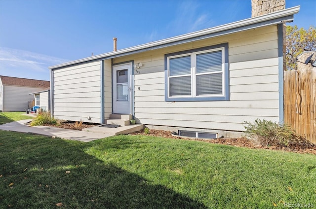 rear view of property with a lawn