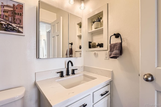 bathroom featuring vanity and toilet