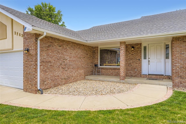3743 W 103rd Dr, Westminster, CO 80031 - view of exterior entry with roof with shingles and brick siding