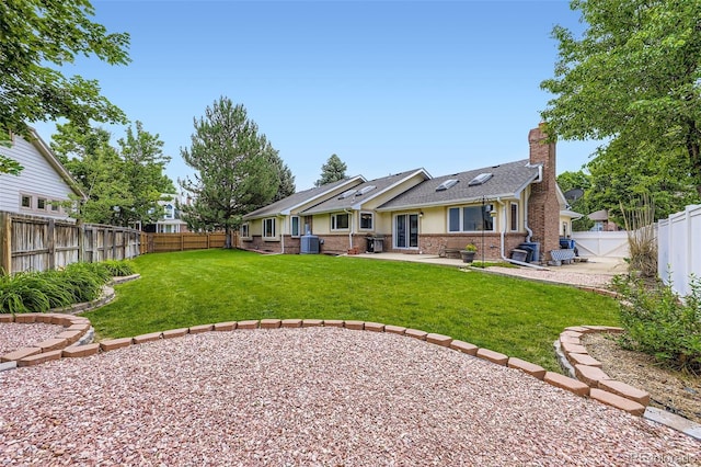 3743 W 103rd Dr, Westminster, CO 80031 - rear view of property with a chimney, a patio area, a fenced backyard, and brick siding