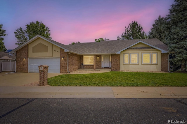 3743 W 103rd Dr, Westminster, CO 80031 - ranch-style home with a lawn, concrete driveway, an attached garage, brick siding, and roof with shingles