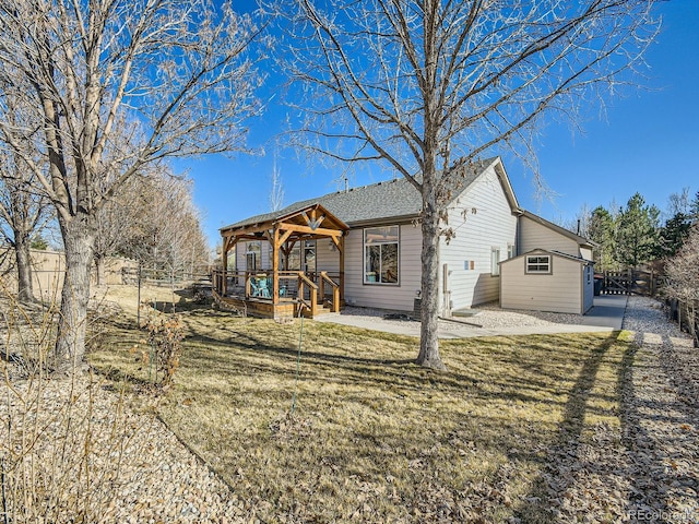 exterior space with a lawn, a patio area, and fence