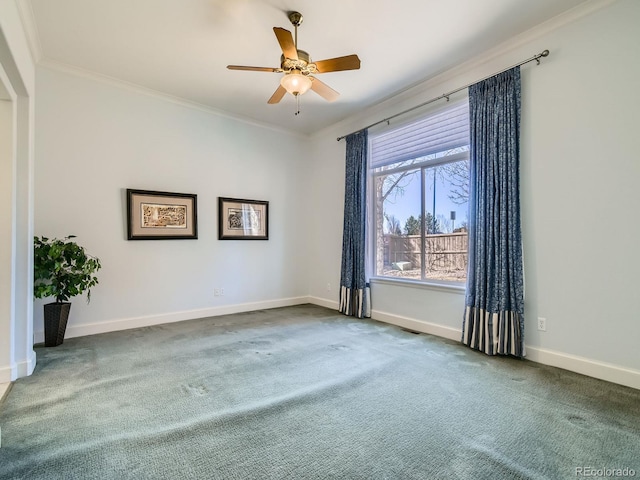 spare room featuring baseboards, carpet floors, and crown molding