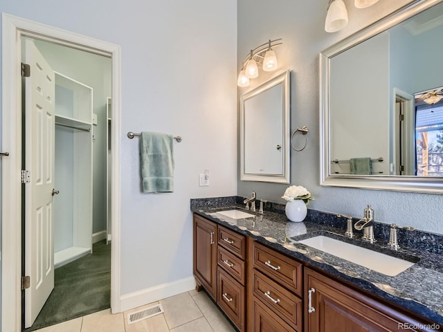 full bathroom featuring tile patterned flooring, visible vents, a sink, and double vanity