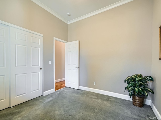 unfurnished bedroom with carpet, crown molding, and baseboards