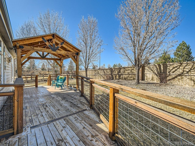 wooden deck featuring a fenced backyard and a gazebo