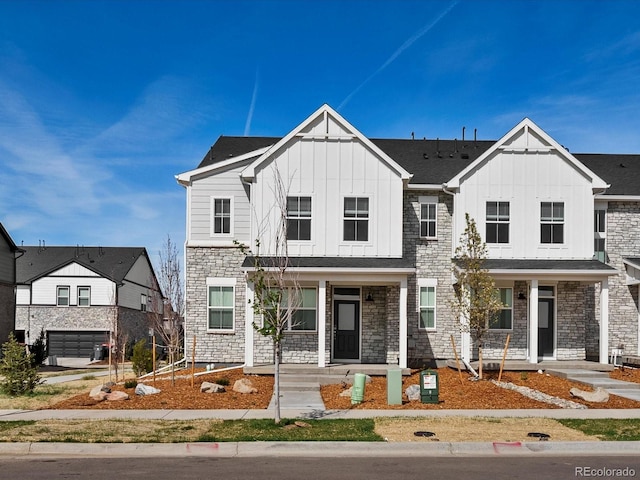 755 N Tibet St, Aurora, CO 80018 - view of front facade with a porch, board and batten siding, and stone siding
