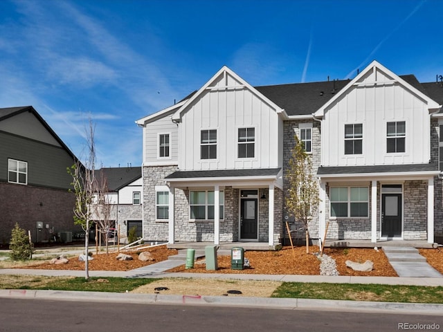 755 N Tibet St, Aurora, CO 80018 - view of front of house with a porch, board and batten siding, and stone siding