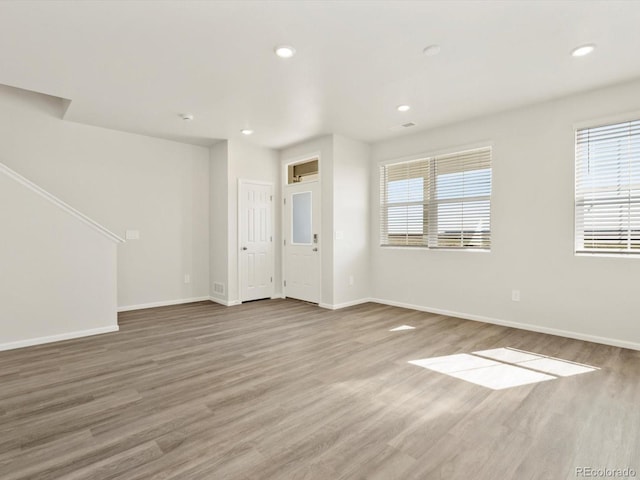 755 N Tibet St, Aurora, CO 80018 - unfurnished living room with wood finished floors, plenty of natural light, baseboards, and recessed lighting