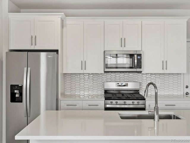 755 N Tibet St, Aurora, CO 80018 - kitchen with stainless steel appliances, light countertops, backsplash, a sink, and white cabinets