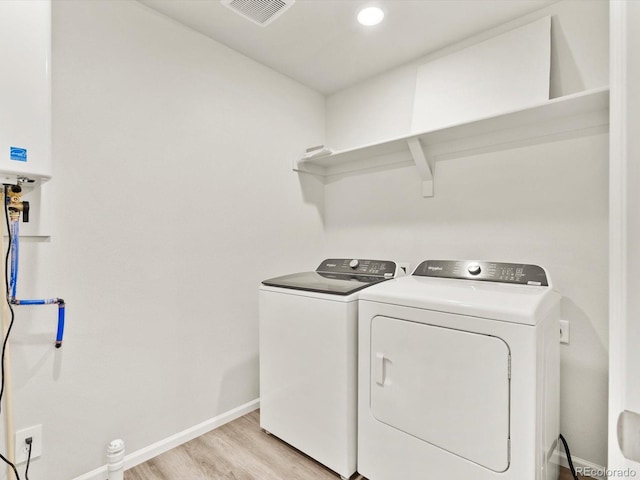 755 N Tibet St, Aurora, CO 80018 - laundry area featuring separate washer and dryer, light wood-style flooring, baseboards, and tankless water heater