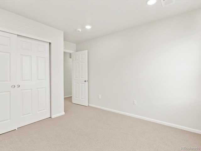 755 N Tibet St, Aurora, CO 80018 - unfurnished bedroom with light colored carpet, a closet, baseboards, and recessed lighting