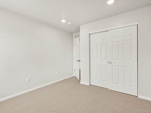 755 N Tibet St, Aurora, CO 80018 - unfurnished bedroom featuring light colored carpet, recessed lighting, baseboards, and a closet
