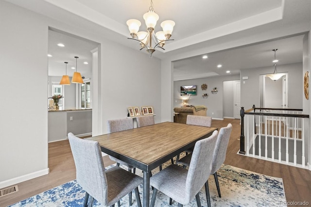 7268 Greenwater Cir, Castle Rock, CO 80108 - dining space featuring a tray ceiling, visible vents, and wood finished floors