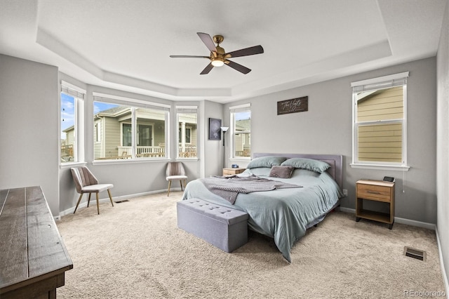 7268 Greenwater Cir, Castle Rock, CO 80108 - carpeted bedroom with a tray ceiling, visible vents, and baseboards