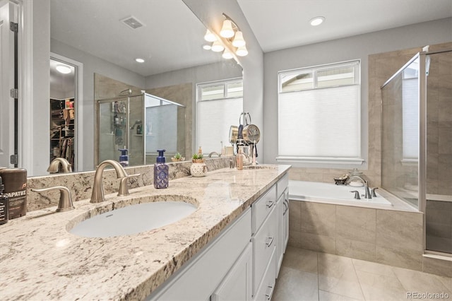 7268 Greenwater Cir, Castle Rock, CO 80108 - bathroom with a garden tub, a shower stall, visible vents, and a sink