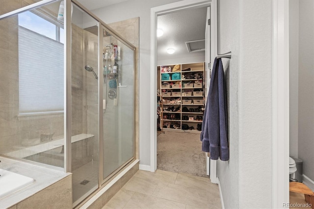 7268 Greenwater Cir, Castle Rock, CO 80108 - full bathroom featuring a walk in closet, a garden tub, a shower stall, and toilet