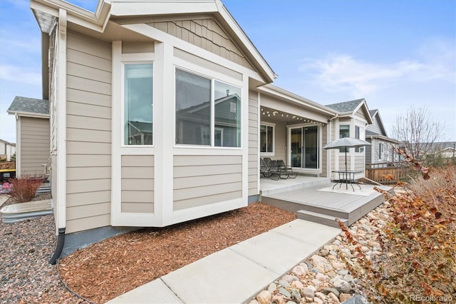 7268 Greenwater Cir, Castle Rock, CO 80108 - view of property exterior featuring roof with shingles, fence, and a wooden deck