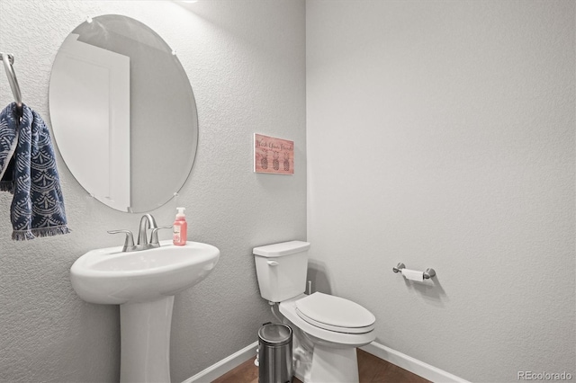 7268 Greenwater Cir, Castle Rock, CO 80108 - bathroom with a textured wall, wood finished floors, toilet, and baseboards