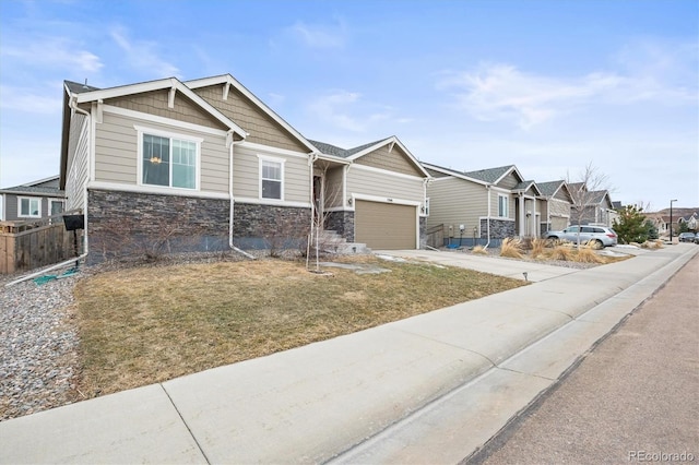 7268 Greenwater Cir, Castle Rock, CO 80108 - craftsman house with stone siding, a residential view, concrete driveway, and fence