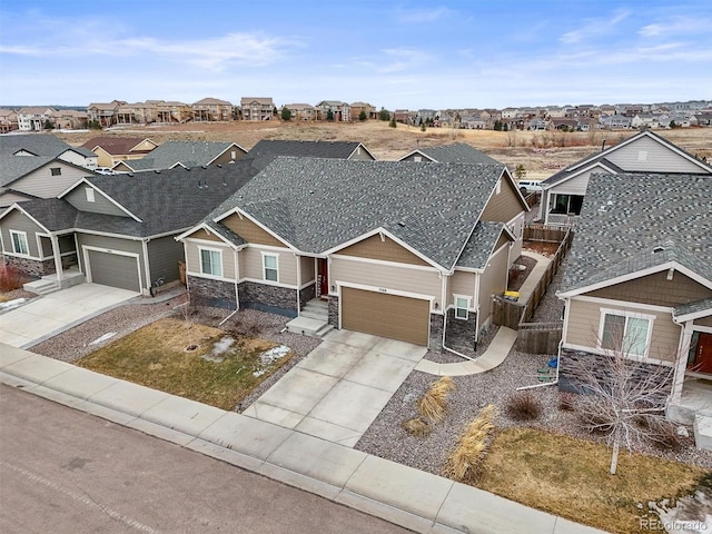 7268 Greenwater Cir, Castle Rock, CO 80108 - view of front of home featuring a shingled roof, fence, a residential view, stone siding, and driveway