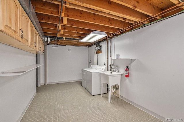 basement with sink and independent washer and dryer