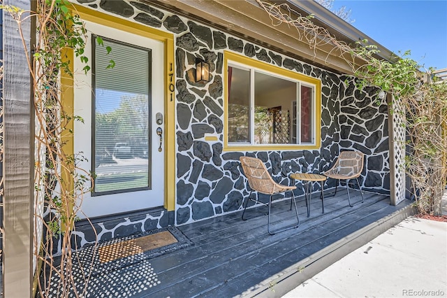 view of exterior entry featuring stone siding