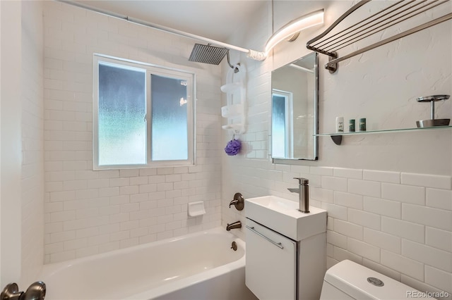 full bathroom with tile walls, toilet, bathtub / shower combination, and vanity