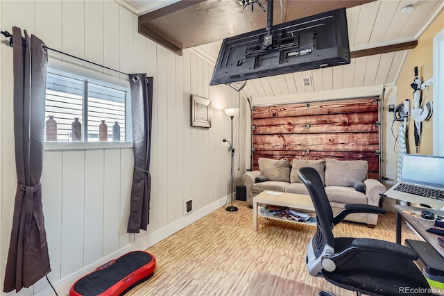 exercise area with baseboards and wood walls