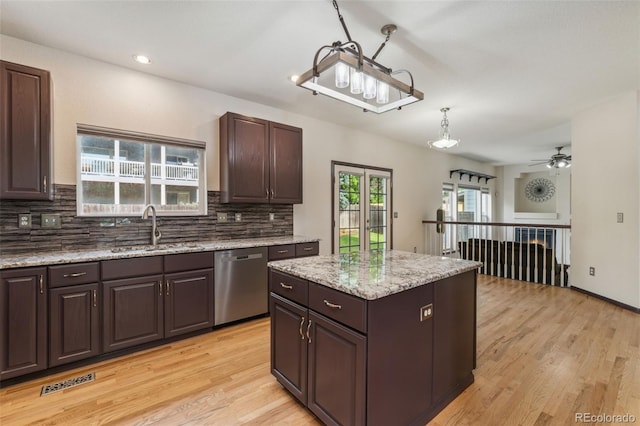 13486 Clayton St, Thornton, CO 80241 - kitchen featuring stainless steel dishwasher, tasteful backsplash, light wood-type flooring, dark brown cabinets, and recessed lighting