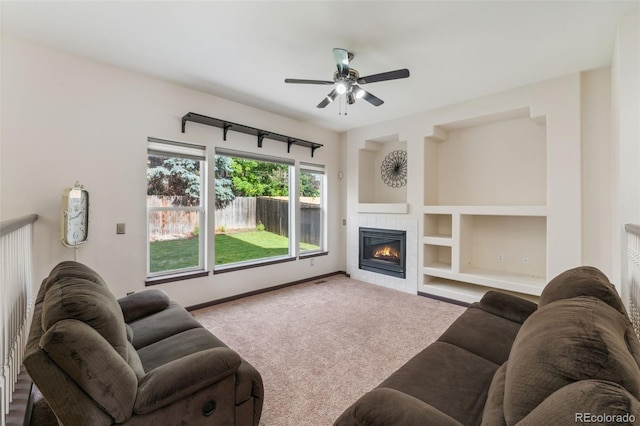 13486 Clayton St, Thornton, CO 80241 - carpeted living room featuring a tile fireplace, ceiling fan, and built in shelves