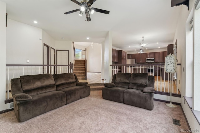 13486 Clayton St, Thornton, CO 80241 - carpeted living room featuring recessed lighting, a ceiling fan, and stairway