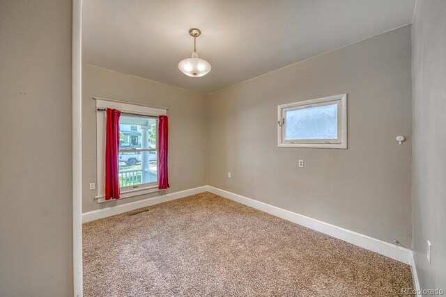 2226 N Greenwood St, Pueblo, CO 81003 - empty room featuring carpet floors, baseboards, and healthy amount of natural light