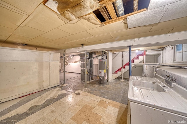 2226 N Greenwood St, Pueblo, CO 81003 - unfinished basement with gas water heater, heating unit, stairway, tile patterned floors, and a sink