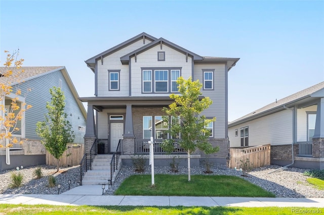 21574 E 59th Dr, Aurora, CO 80019 - view of front facade with covered porch, fence, and brick siding