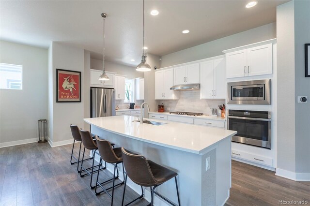 21574 E 59th Dr, Aurora, CO 80019 - kitchen featuring stainless steel appliances, a sink, dark wood-type flooring, decorative backsplash, and recessed lighting