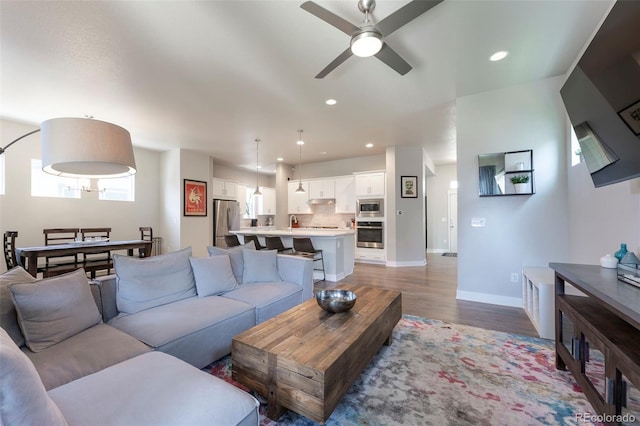 21574 E 59th Dr, Aurora, CO 80019 - living area featuring ceiling fan, wood finished floors, baseboards, and recessed lighting