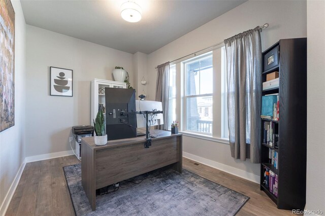 21574 E 59th Dr, Aurora, CO 80019 - home office with wood finished floors and baseboards